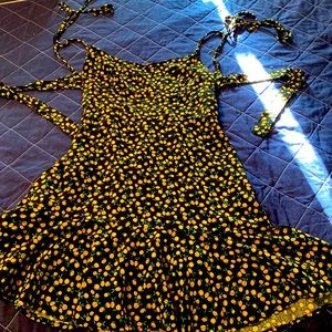 Super cute over the shoulder and tie in mid back mini black dress!